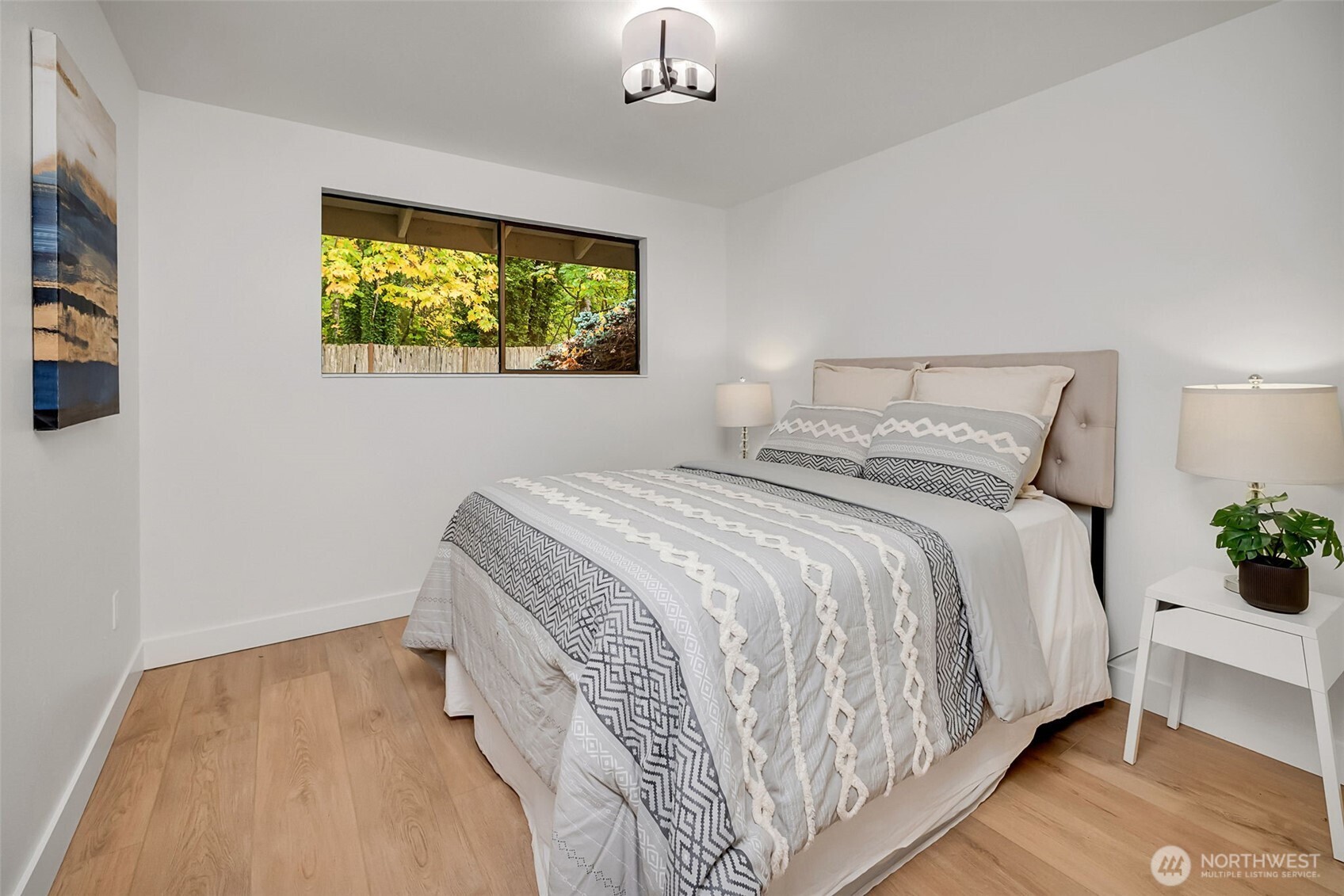16123 Southeast 146th Place Renton, WA 98059 - Photo 32 of 40 a bedroom with a bed and a chandelier