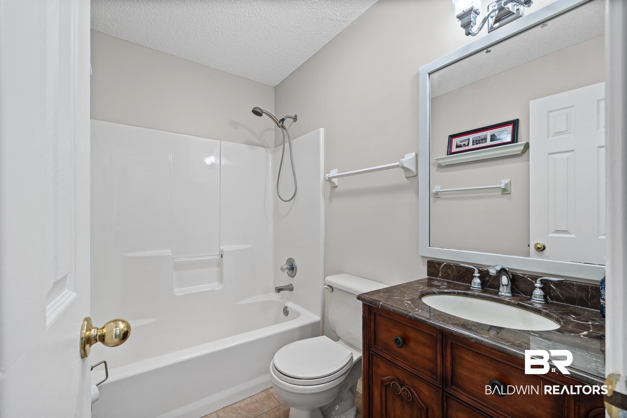 2881 Eslava Circle Lillian, AL 36549 - Photo 21 of 58 Bathroom featuring vanity, a textured ceiling, shower / bath combination, and light tile patterned flooring