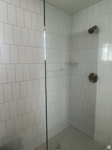 4740 West 25 North West Point, UT 84015 - Photo 15 of 15 Shower enclosure featuring white vertical subway tile, glass shower panel, bronze shower fixtures, and a white penny tile shower pan