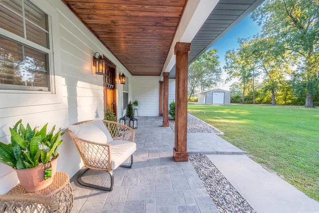 a view of a house with porch and garden