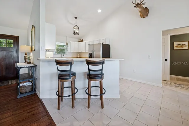 a view of a dining room with furniture wooden floor and chandelier