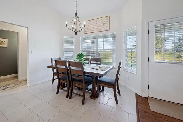 a living room with furniture a flat screen tv and wooden floor