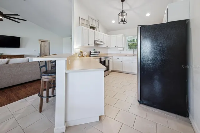 a kitchen with cabinets appliances and a sink