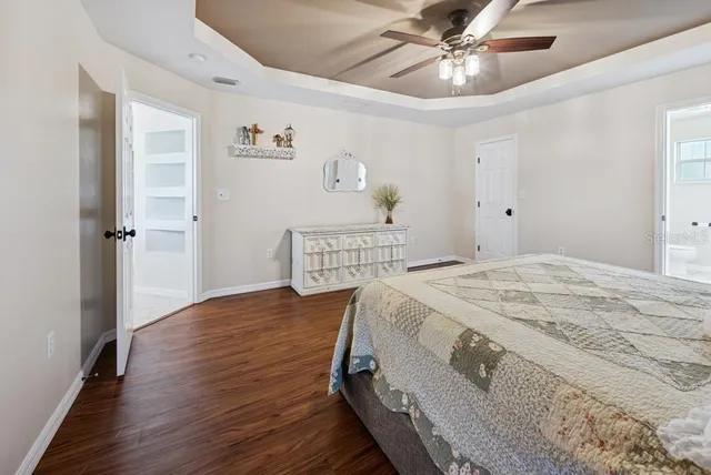a bathroom with a granite countertop toilet and a shower