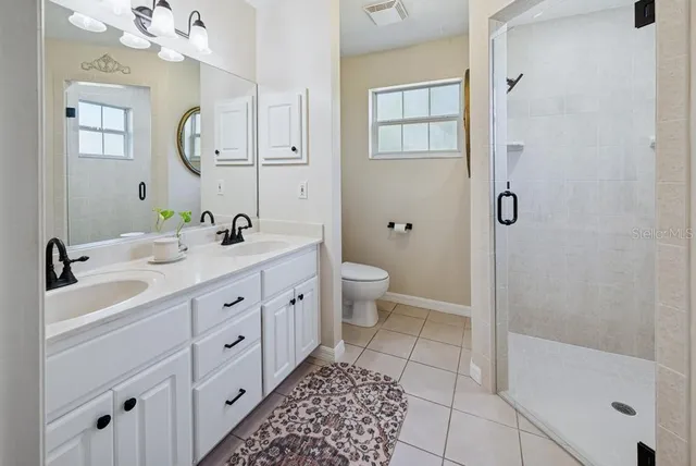 a white toilet sitting next to a bathroom sink
