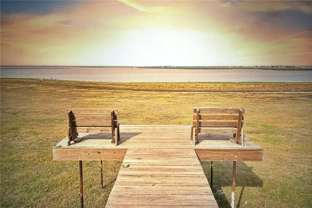 a view of a ocean with a table and chairs