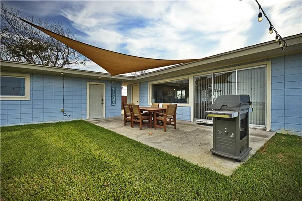 a view of a backyard with table and chairs