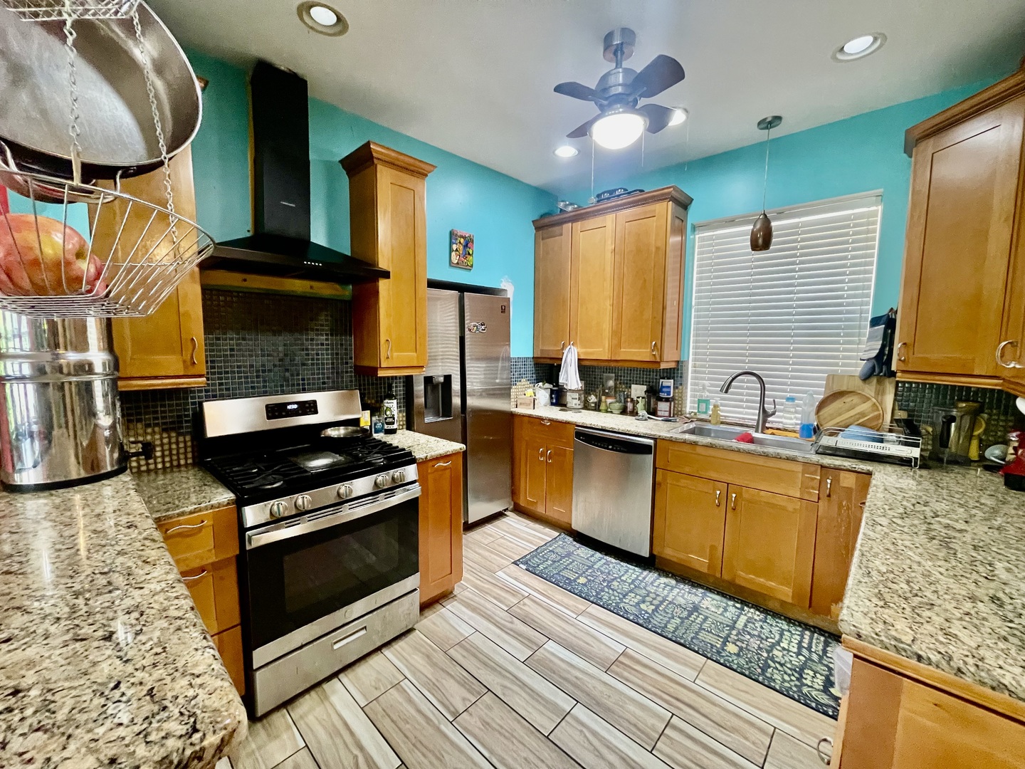 7916 South Constance Avenue Chicago, IL 60617 - Photo 12 of 28 a kitchen with stainless steel appliances granite countertop a stove a sink and a microwave