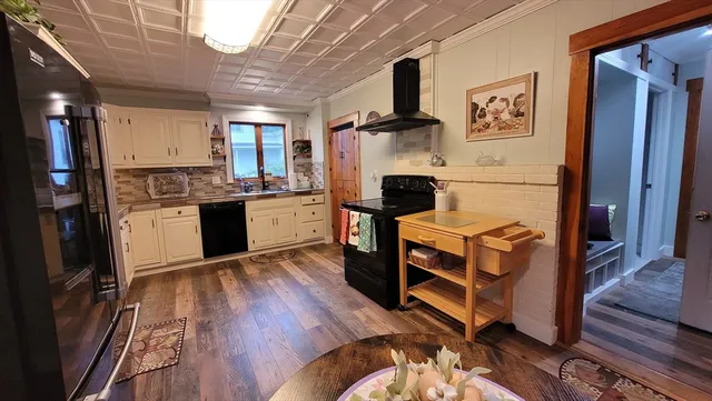 a kitchen with stainless steel appliances granite countertop a refrigerator a stove and a refrigerator