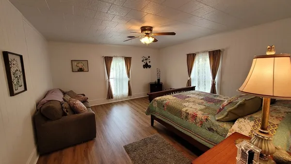 a bedroom with a bed and a chandelier