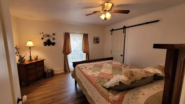 a view of a dining room with furniture and wooden floor