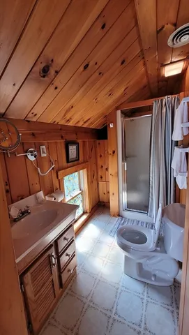 a bedroom with a bed mirror and window