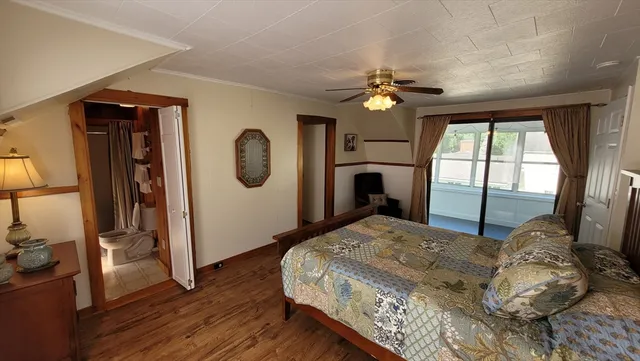 a bedroom with a bed mirror and a window