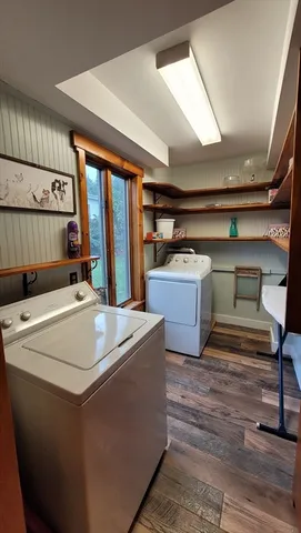 a living room with furniture pool table and a fireplace