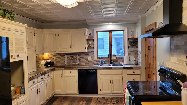 a kitchen with granite countertop stainless steel appliances and wooden cabinets