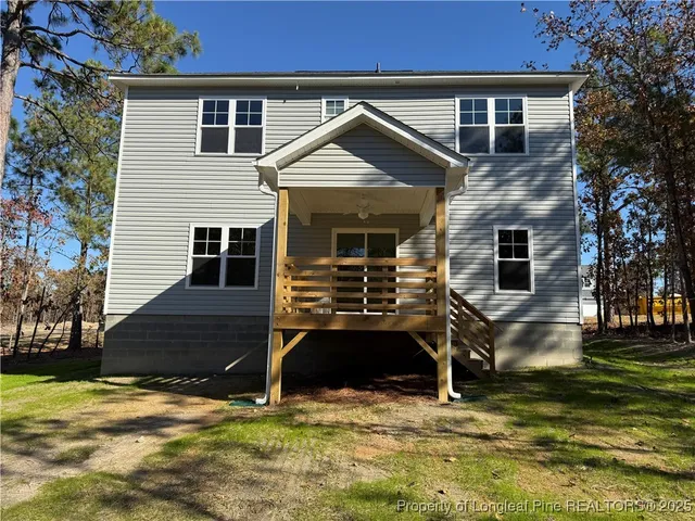 a view of house with yard in front of it