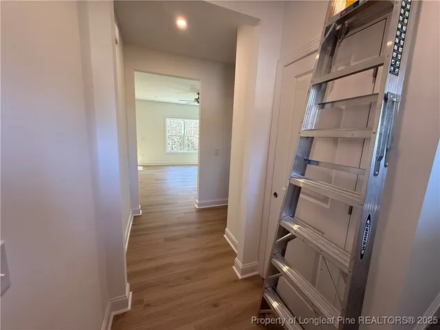 a view of a room with wooden floor