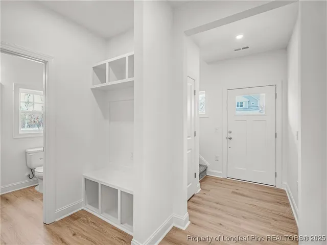 a view of wooden floor and windows in a room