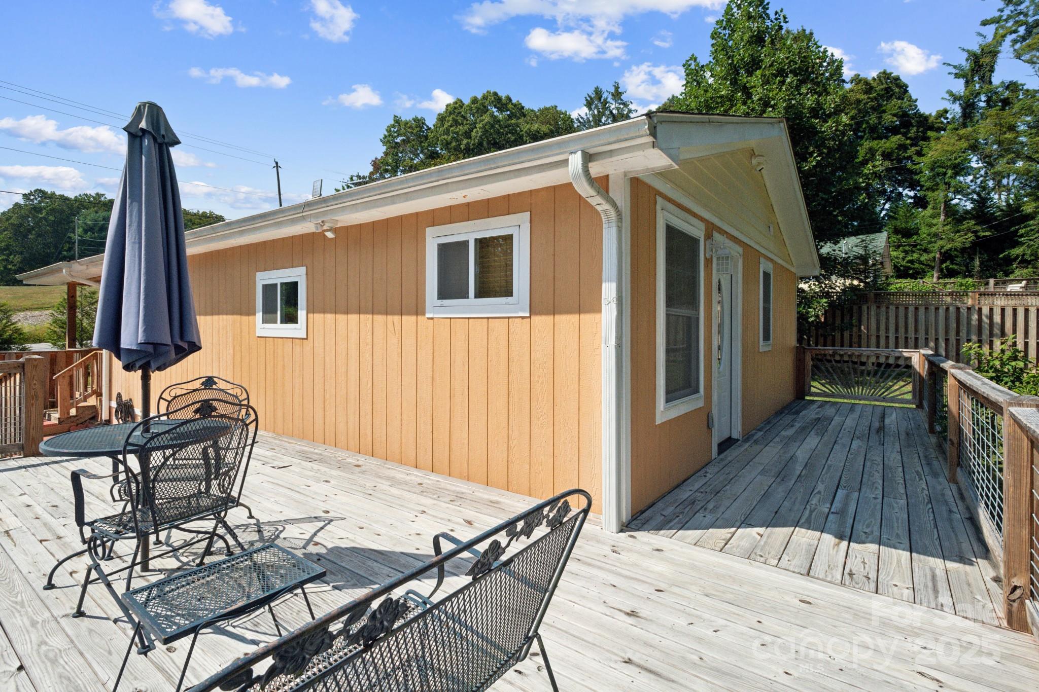 660 Pace Road Hendersonville, NC 28792 - Photo 18 of 31 a view of a house with backyard and sitting area