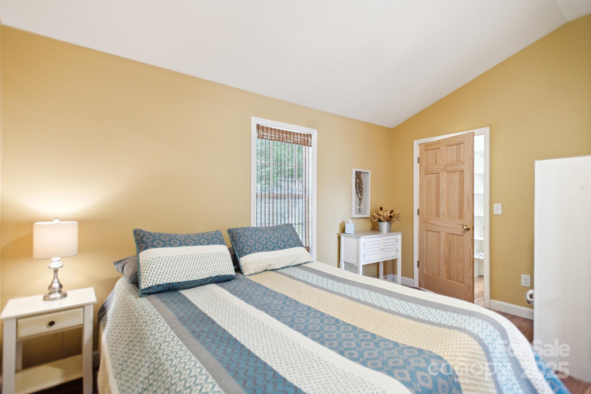 660 Pace Road Hendersonville, NC 28792 - Photo 2 of 31 a bedroom with a bed and a lamp