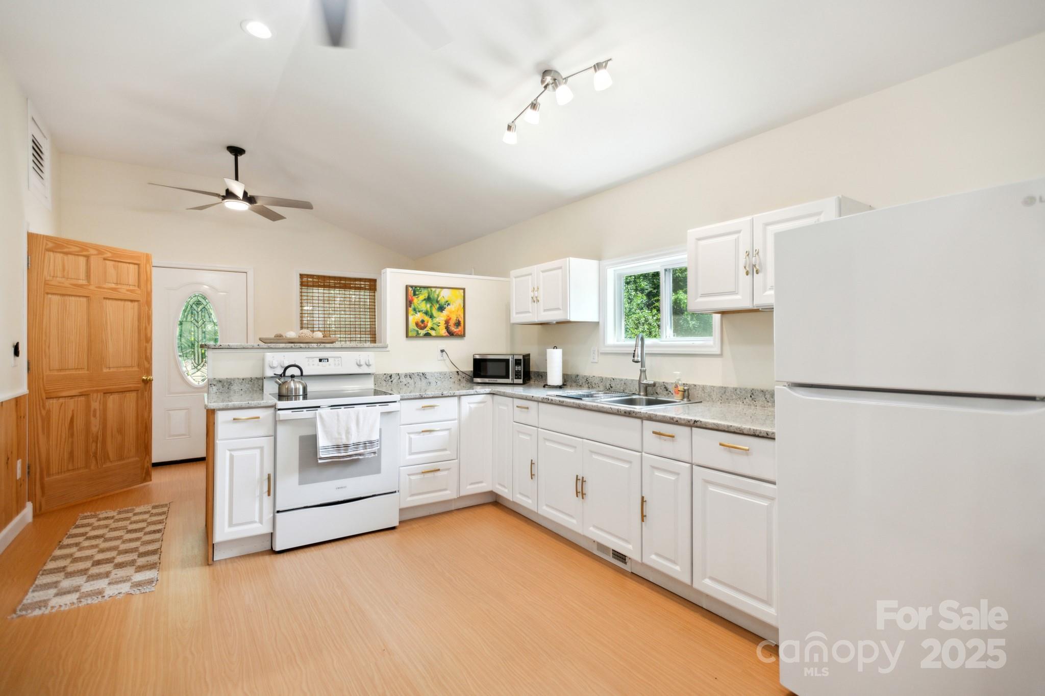 660 Pace Road Hendersonville, NC 28792 - Photo 3 of 31 a kitchen with granite countertop a sink appliances cabinets and counter space