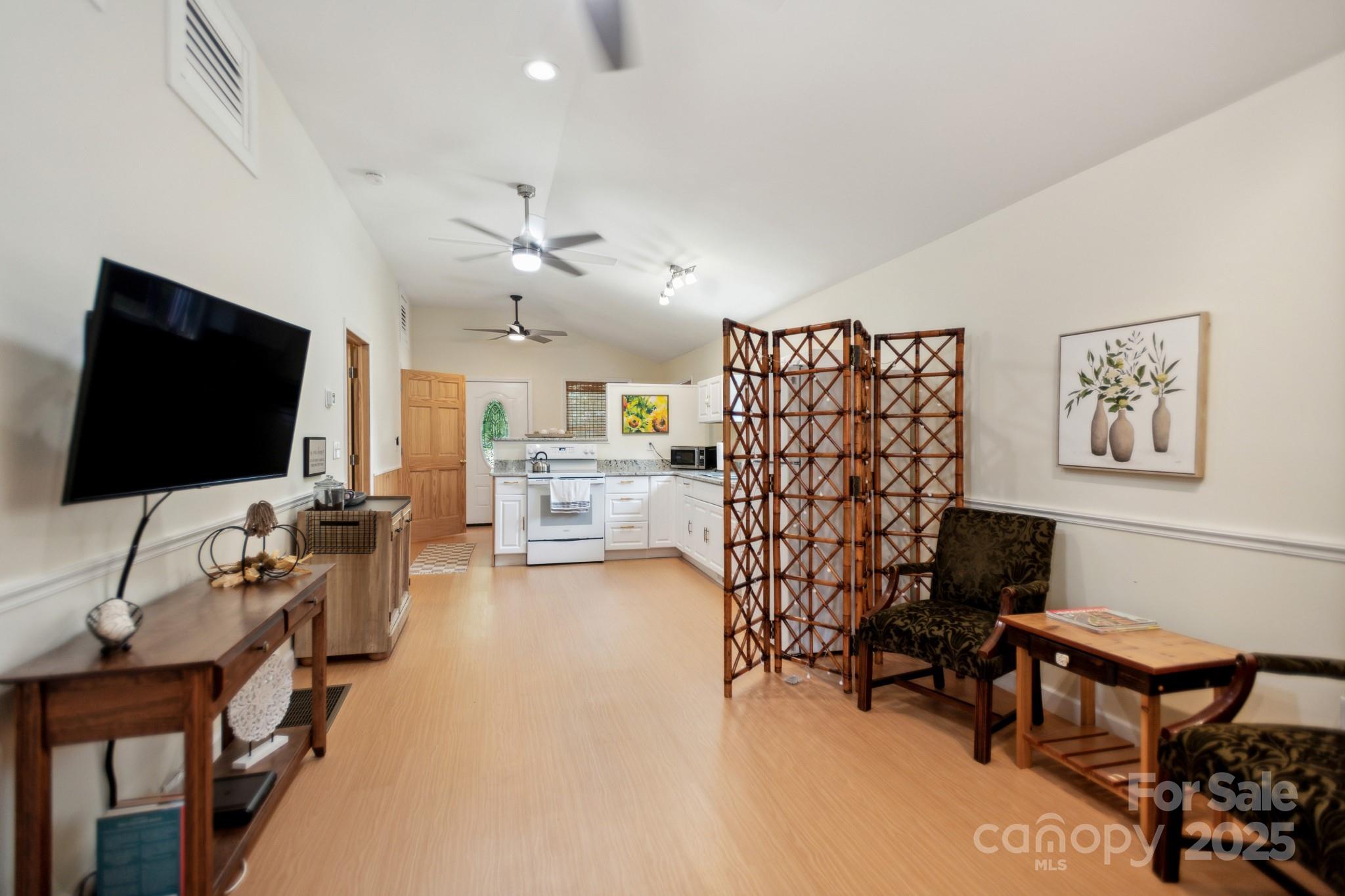 660 Pace Road Hendersonville, NC 28792 - Photo 5 of 31 a living room with furniture and a flat screen tv
