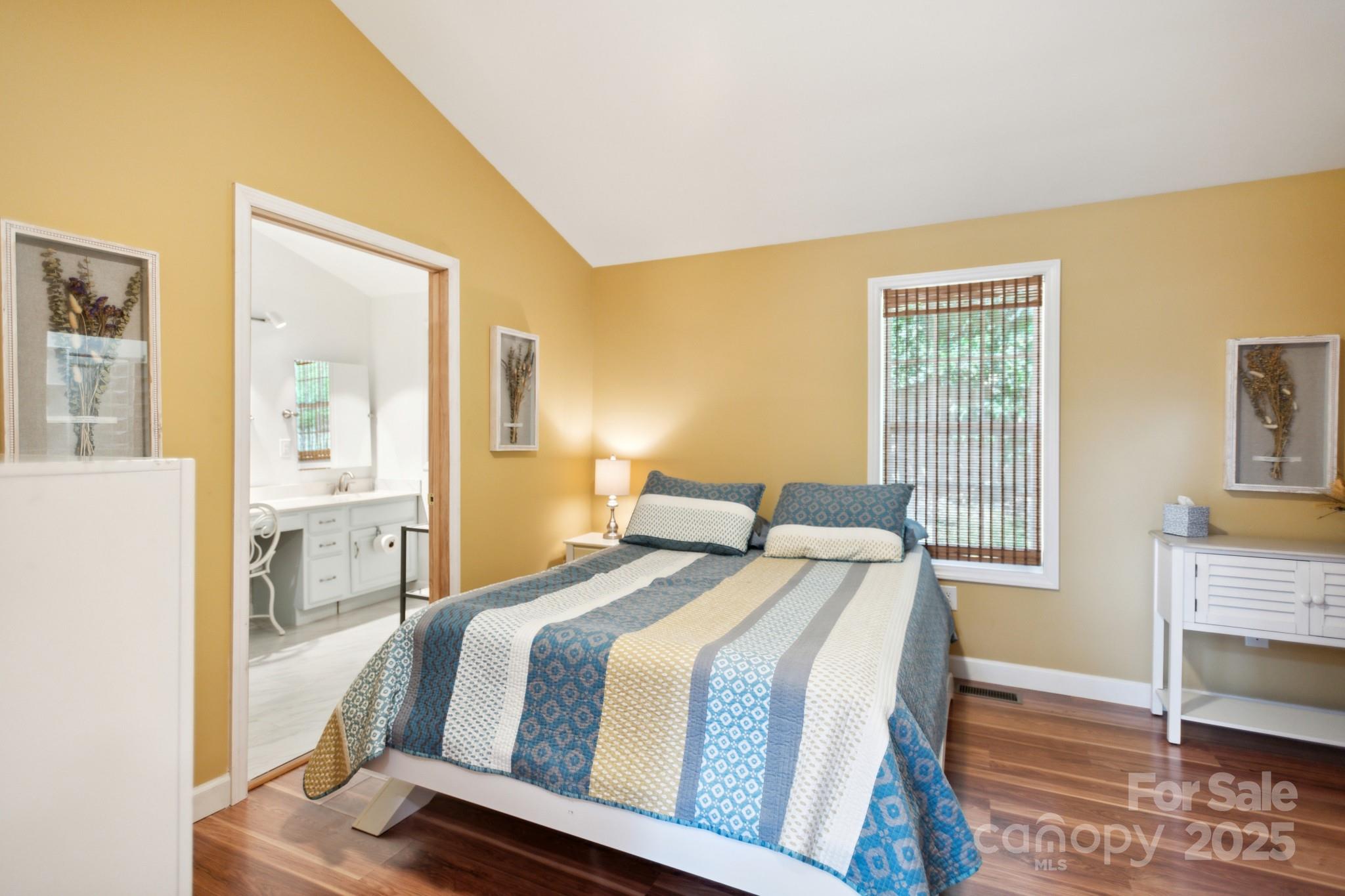 660 Pace Road Hendersonville, NC 28792 - Photo 10 of 31 a bedroom with a bed and wooden floor