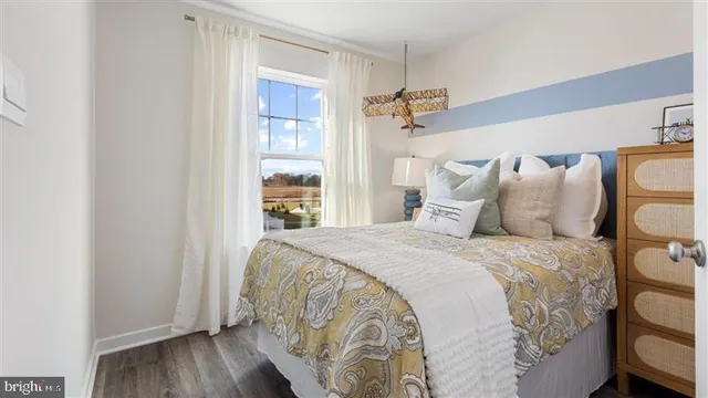 a bed sitting in a bedroom next to a window