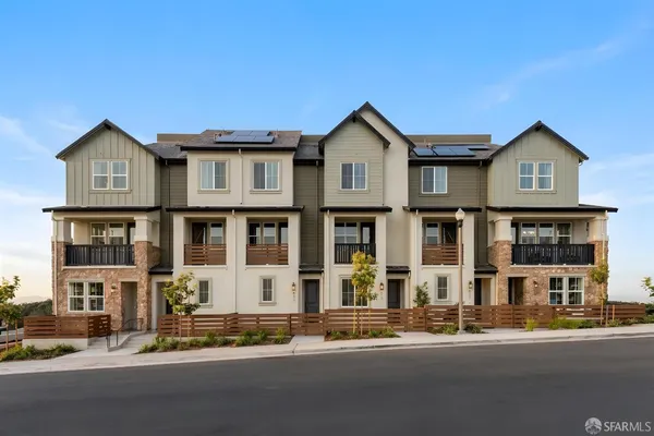 a front view of a residential apartment building with a yard