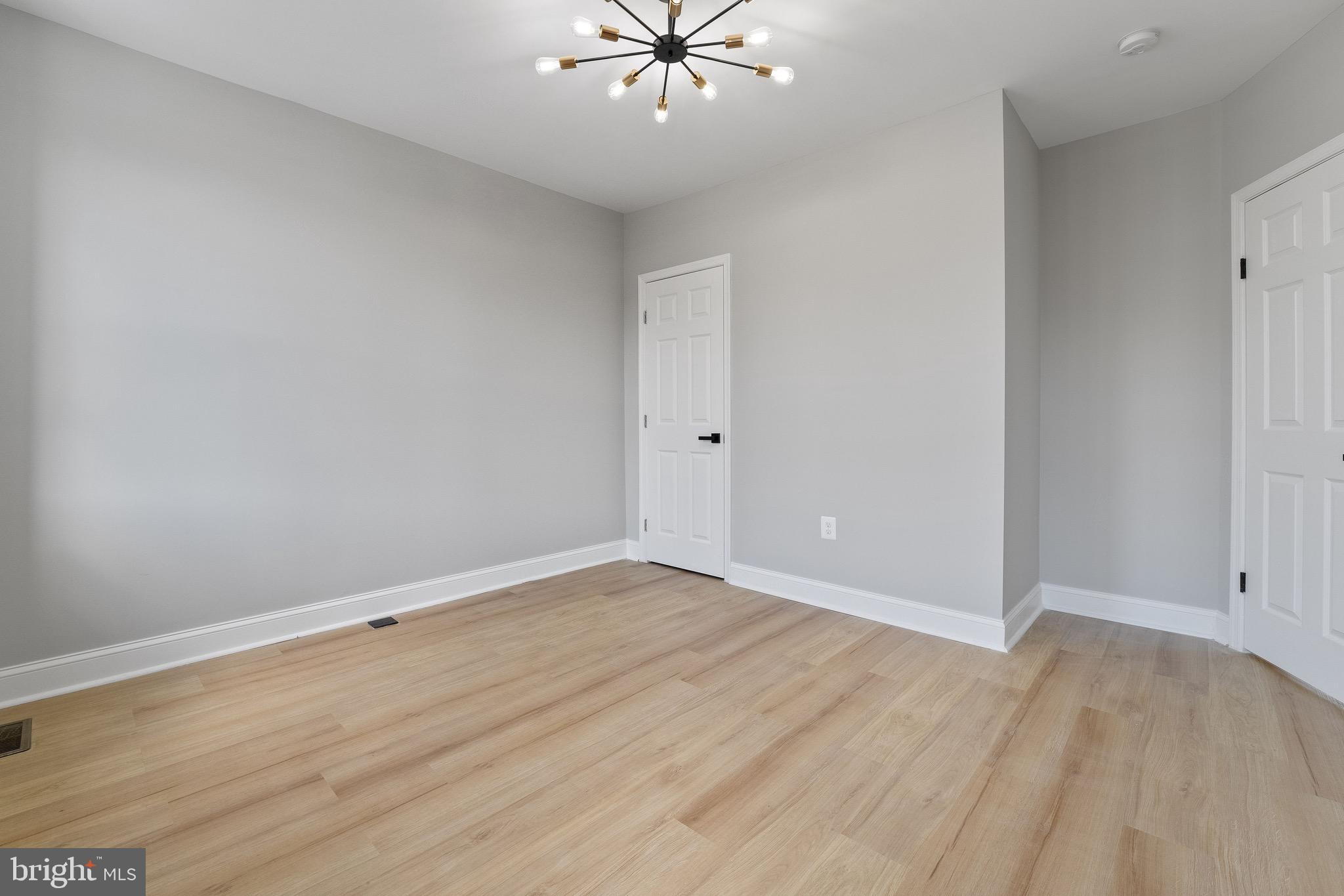 655 Dumbarton Avenue Baltimore, MD 21218 - Photo 17 of 28 wooden floor in an empty room