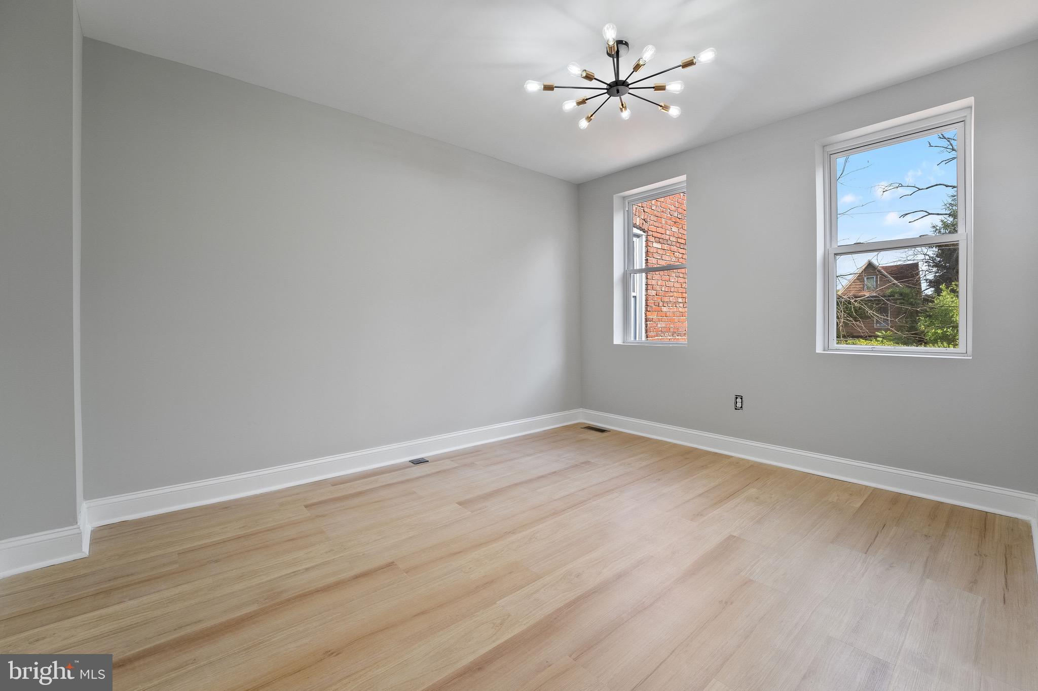 655 Dumbarton Avenue Baltimore, MD 21218 - Photo 18 of 28 wooden floor in an empty room with a window