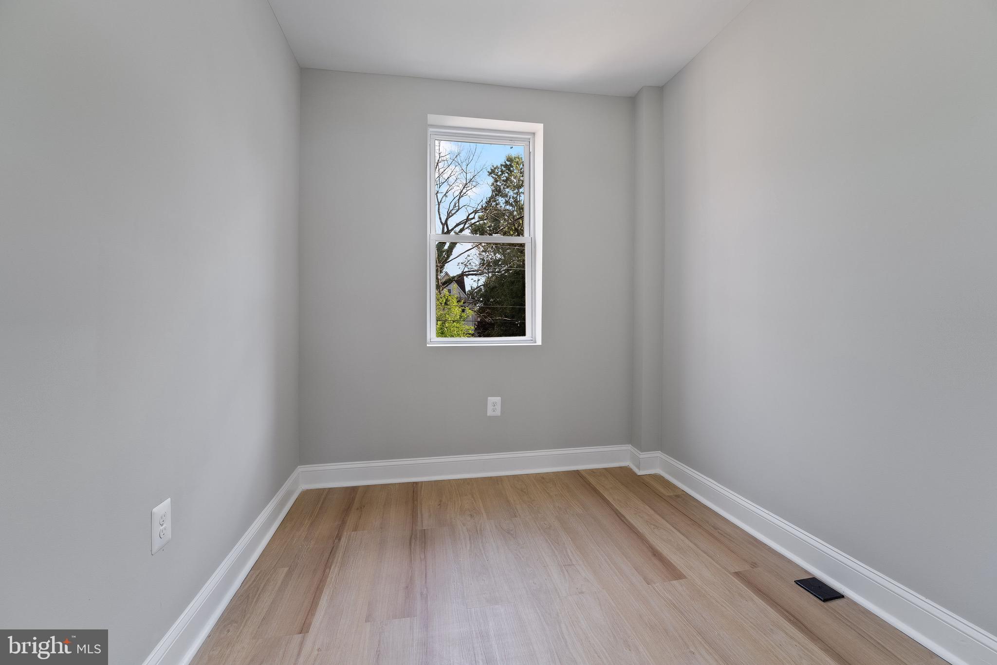 655 Dumbarton Avenue Baltimore, MD 21218 - Photo 20 of 28 a view of room with window and wooden floor
