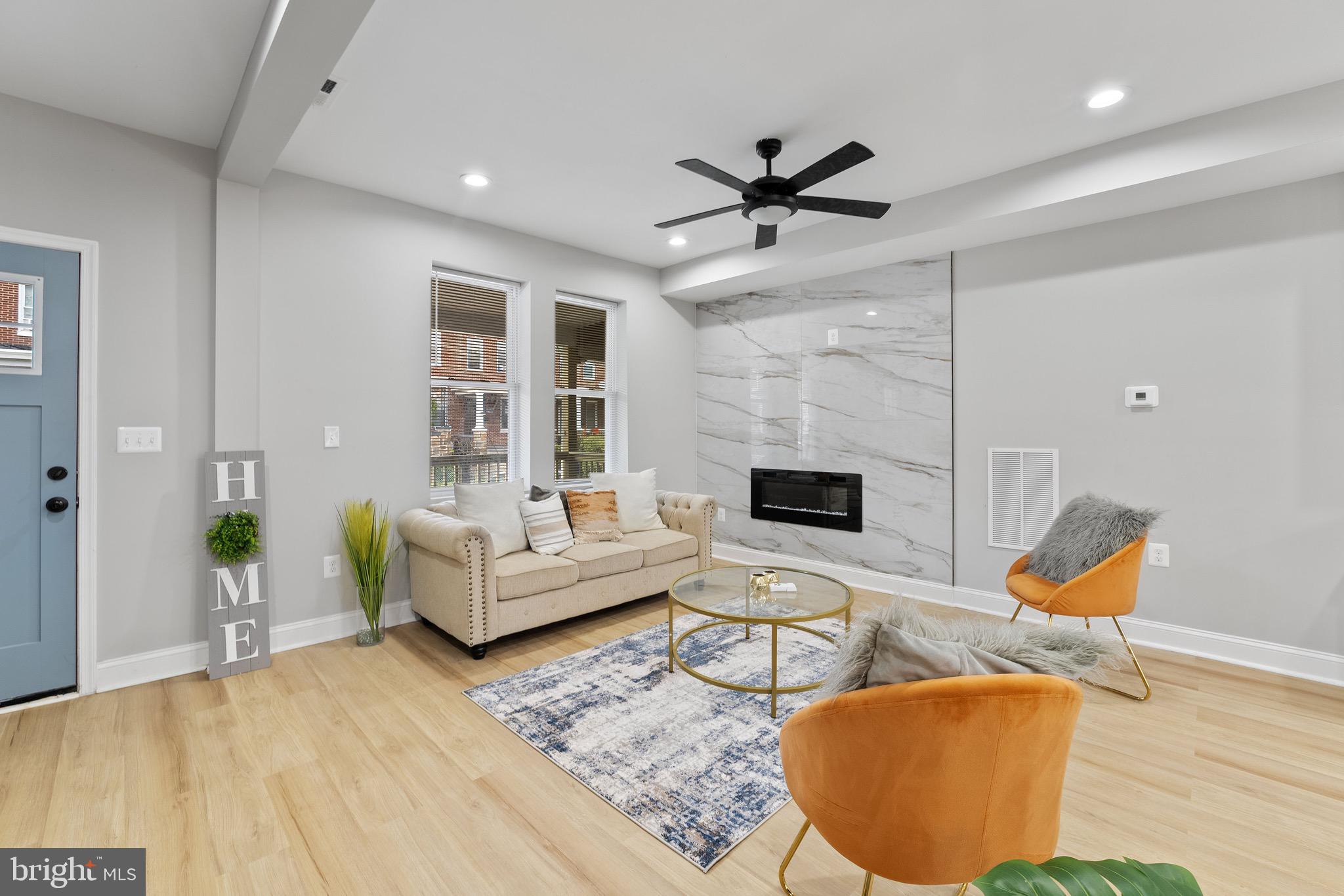 655 Dumbarton Avenue Baltimore, MD 21218 - Photo 2 of 28 a living room with furniture and a fireplace