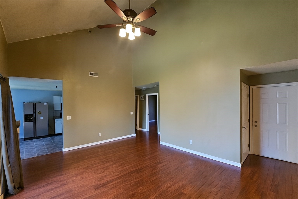 124 Tennis Plaza Road, Unit 22 Dracut, MA 01826 - Photo 2 of 9 a view of empty room with wooden floor