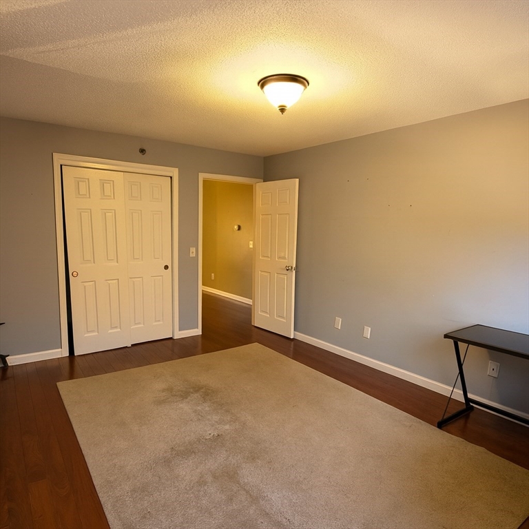 124 Tennis Plaza Road, Unit 22 Dracut, MA 01826 - Photo 5 of 9 an empty room with closet area