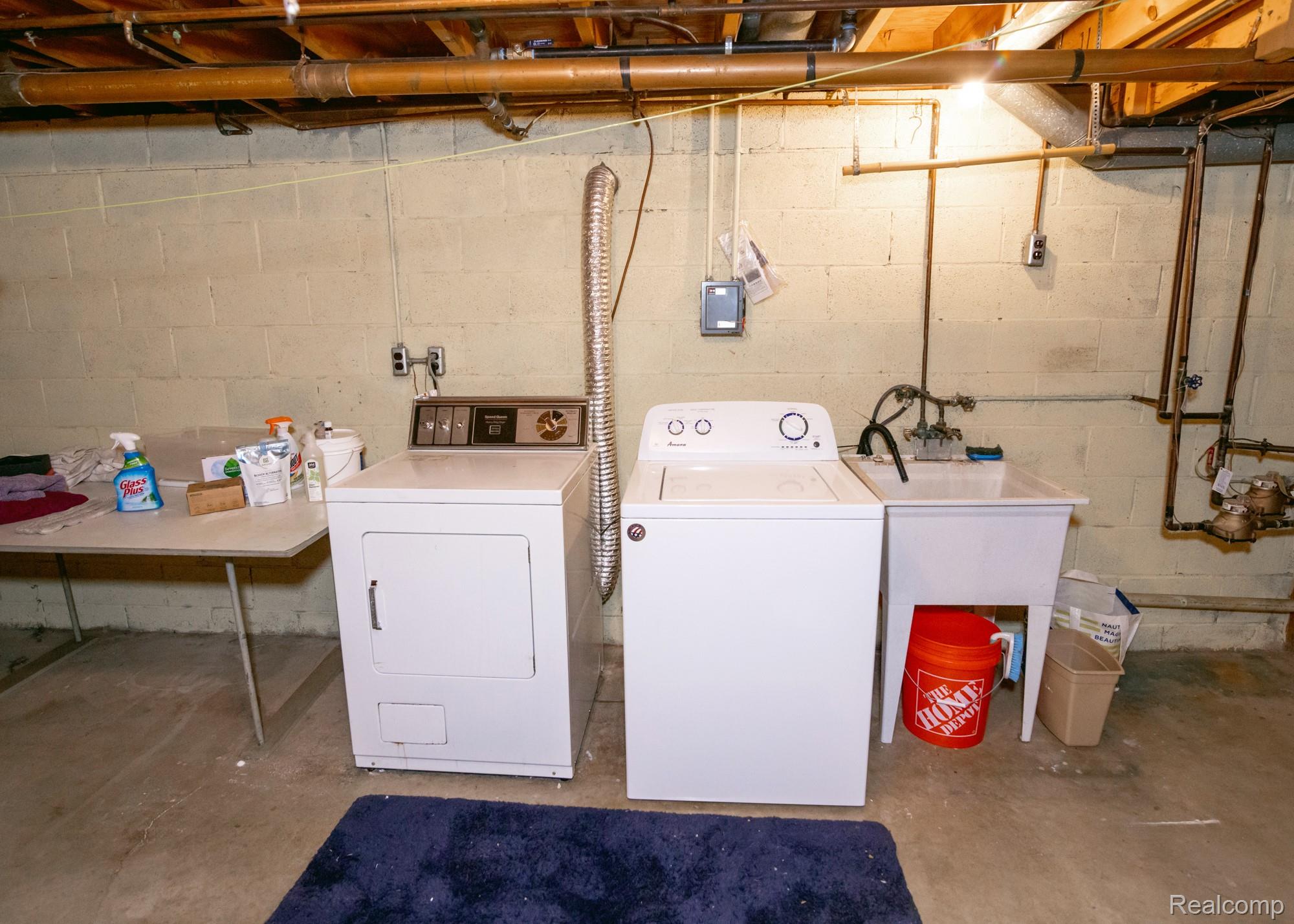 724 Sandstone Drive Rochester, MI 48309 - Photo 40 of 60 Laundry area featuring a utility sink, a washer, and a dryer