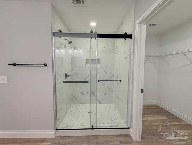 a bathroom with a glass shower door