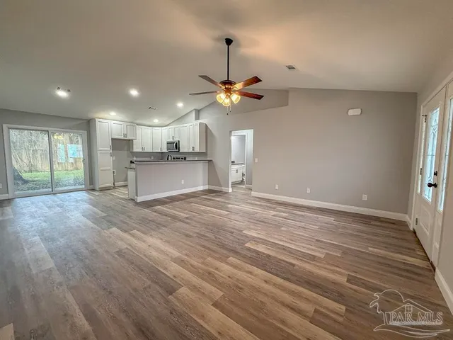 a view of a kitchen with a dishwasher and wooden floor