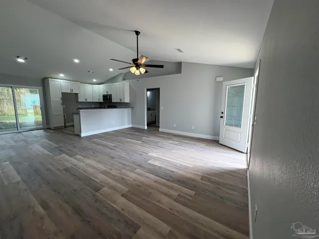 a kitchen that has a lot of cabinets a sink and appliances in it