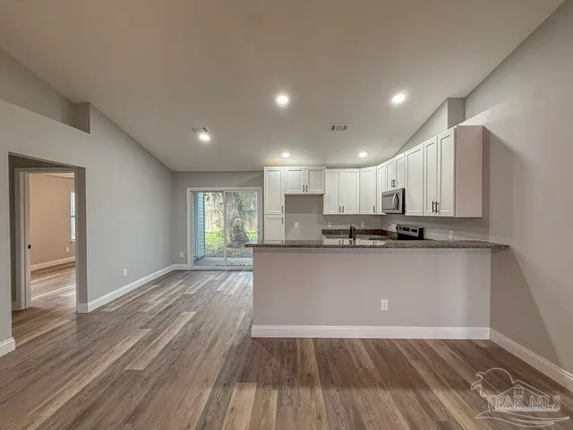 a view of kitchen with wooden floor
