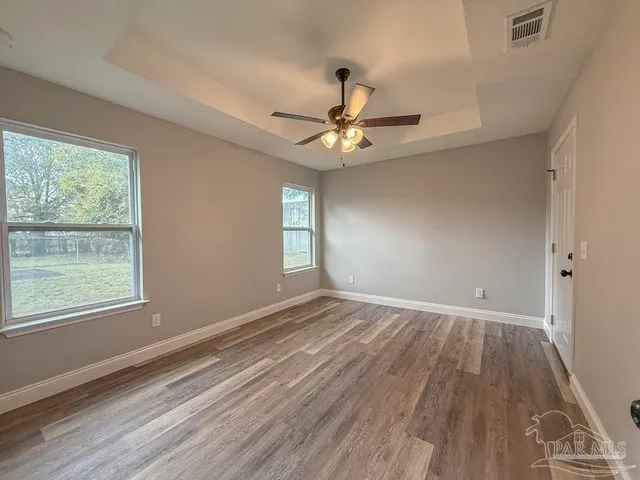 wooden floor in an empty room with a window