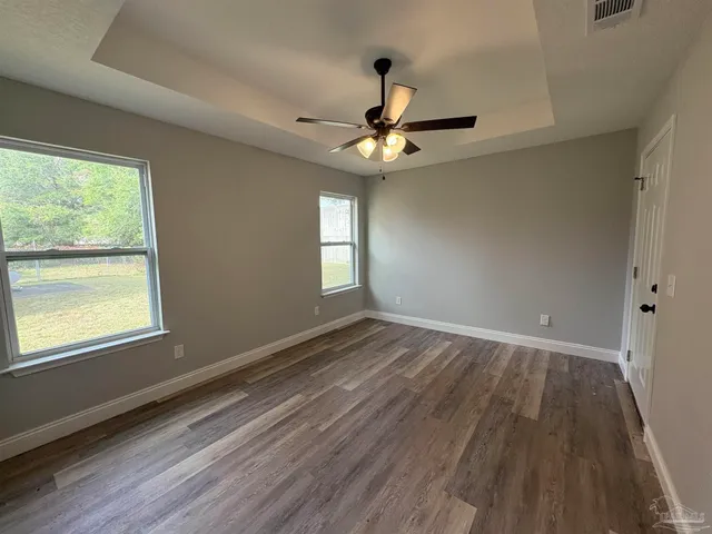 a view of hallway with wooden floor