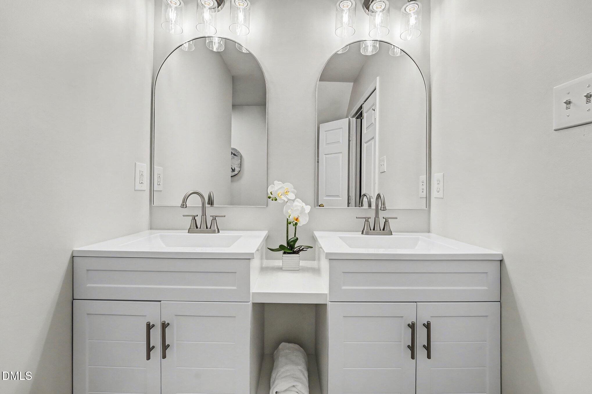 1005 Winsome Court Raleigh, NC 27603 - Photo 11 of 20 a bathroom with double vanity sinks and a mirror