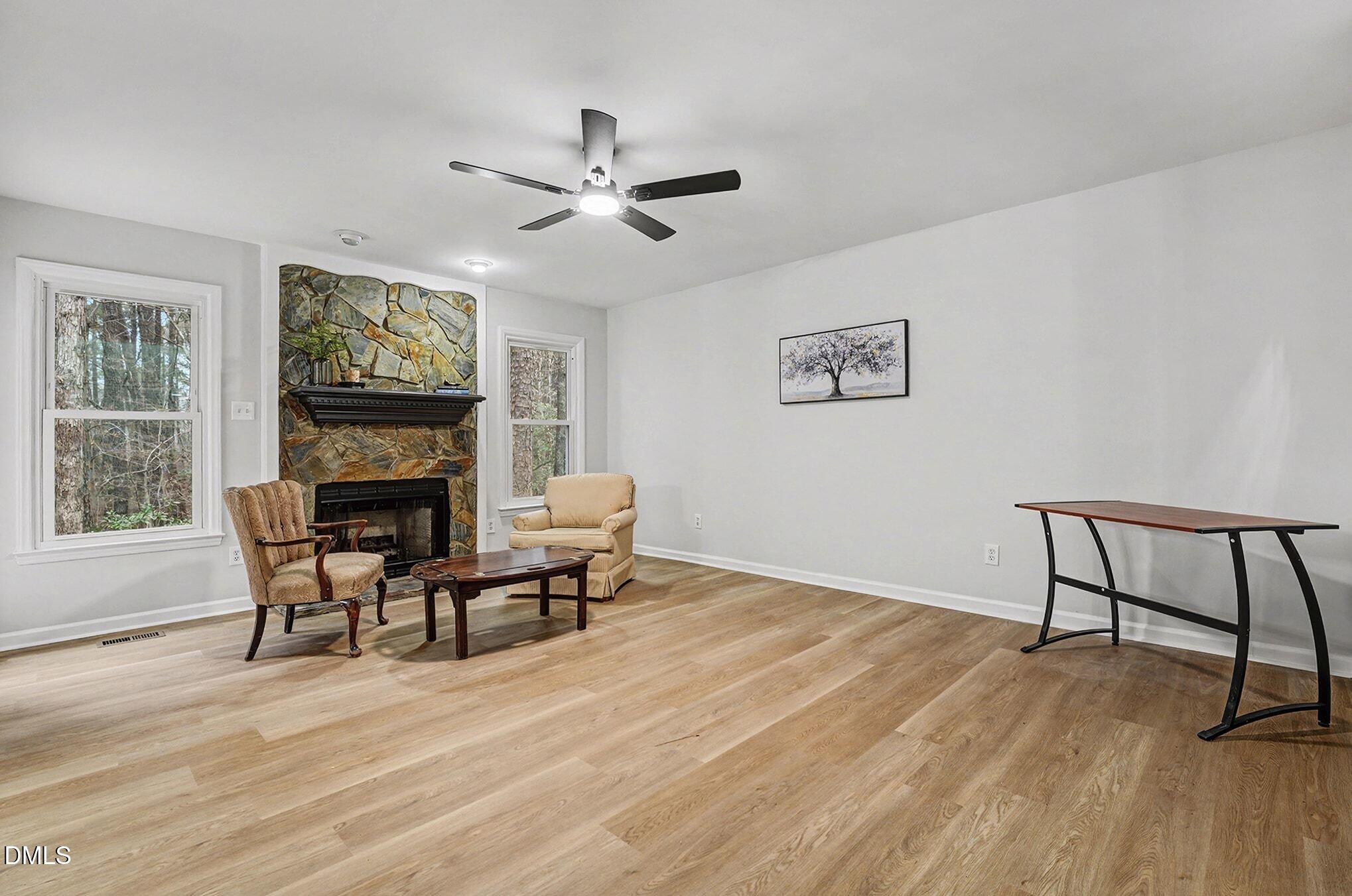 1005 Winsome Court Raleigh, NC 27603 - Photo 6 of 20 a living room with furniture a window and a fireplace
