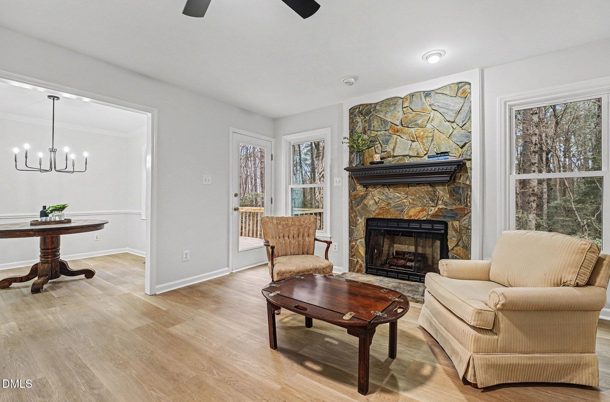 1005 Winsome Court Raleigh, NC 27603 - Photo 7 of 20 a living room with furniture a flat screen tv and a fireplace
