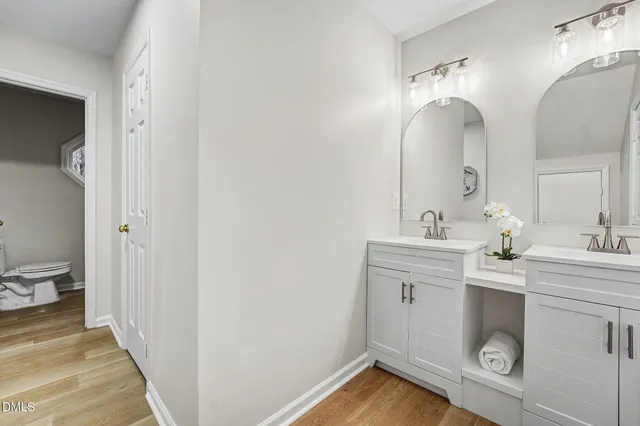 a spacious bathroom with a double vanity sink and a mirror
