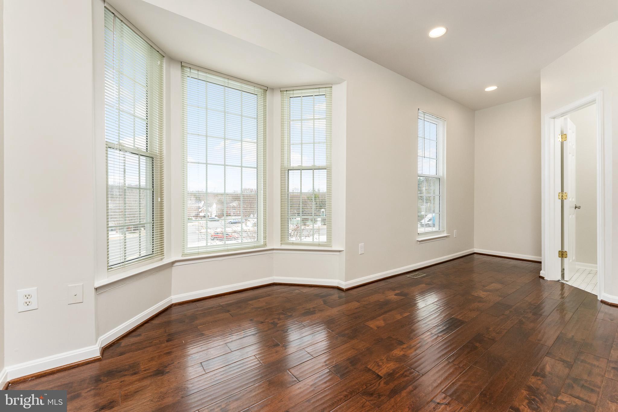 5311 Yellow Turtle Place Woodbridge, VA 22193 - Photo 13 of 36 a view of an empty room with wooden floor and a window