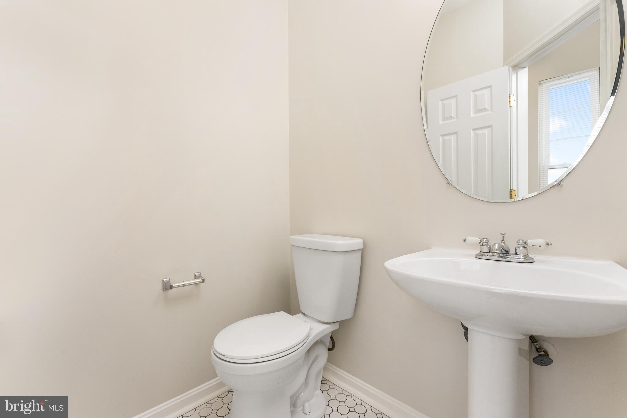 5311 Yellow Turtle Place Woodbridge, VA 22193 - Photo 14 of 36 a bathroom with a sink toilet and a mirror