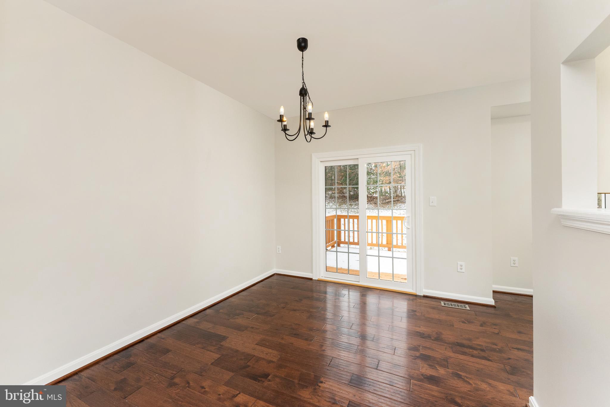 5311 Yellow Turtle Place Woodbridge, VA 22193 - Photo 15 of 36 an empty room with wooden floor and windows