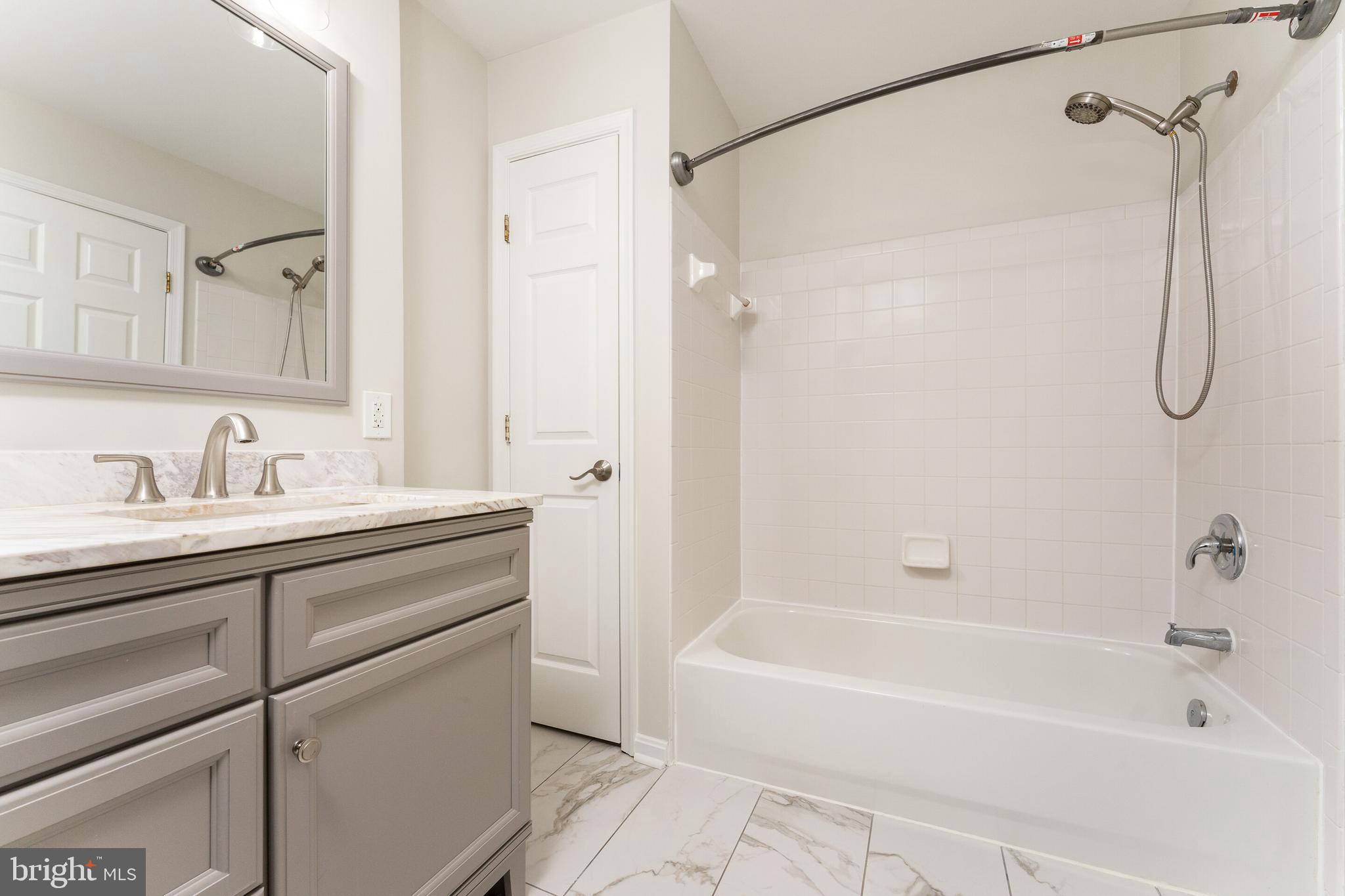 5311 Yellow Turtle Place Woodbridge, VA 22193 - Photo 21 of 36 a bathroom with a tub shower sink and vanity
